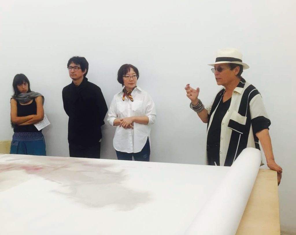 (Mera Rubell, right, welcomes FIU's Professor Lidu Yi, the artist Lan Zhenghui and students to the Rubell Family Collection in Miami)
