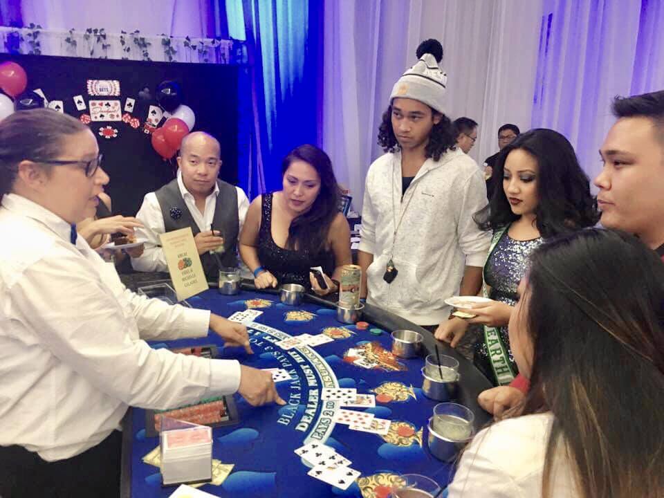 The guests getting free lessons on how to play with their paper money.