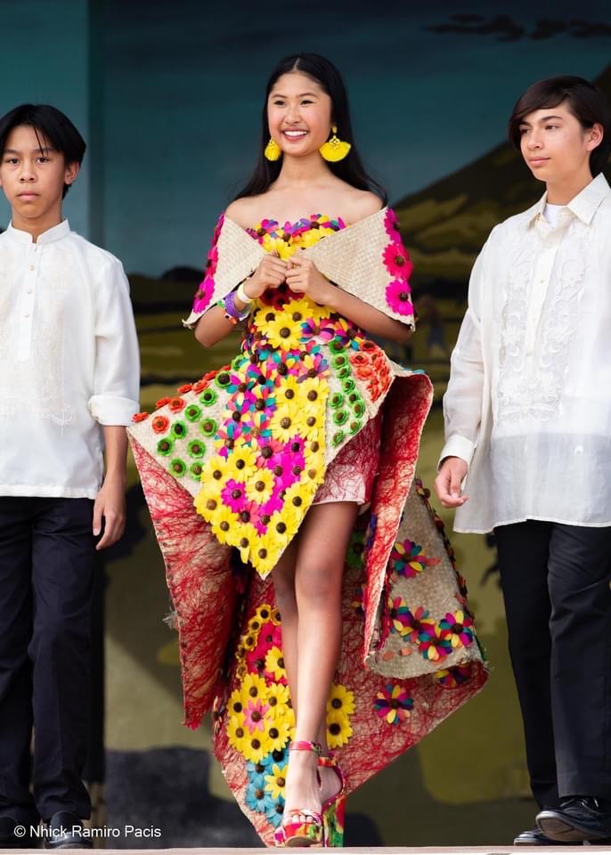 A young Filipina child sporting dress made of recycled col…