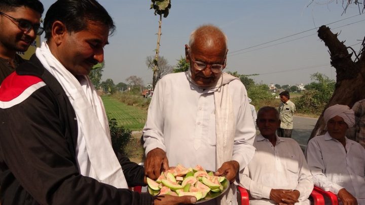 Kapil Sharma (left) offers pieces of guavas to local residents in this recent photo.