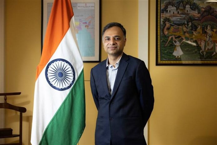 India's representative to Taiwan Manharsinh Laxmanbhai Yadav poses for a picture alongside the Indian national flag in Taipei on October 2