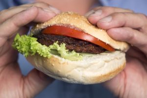 A beef burger created by stem cells harvested from a living cow is held for a photograph by Mark Post, a Dutch scientist, following a Bloomberg Television interview in London, U.K., on Tuesday, Aug. 6, 2013. The 5-ounce burger, which cost more than 250,000 euros ($332,000) to produce, was developed by Post of Maastricht University with funding from Google co-founder Sergey Brin. Photographer: Simon Dawson/Bloomberg via Getty Images