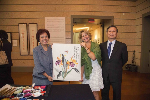 Ms Panxiong Hua presented a painting to Christine Rupp-Coral Gables Museum curator